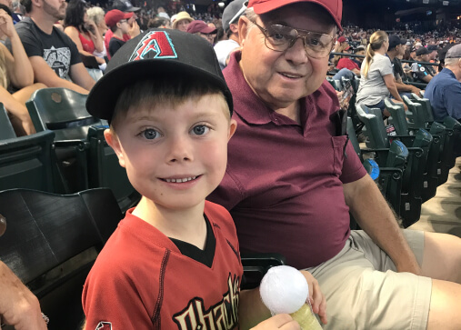 Kid and Dad watching baseball game